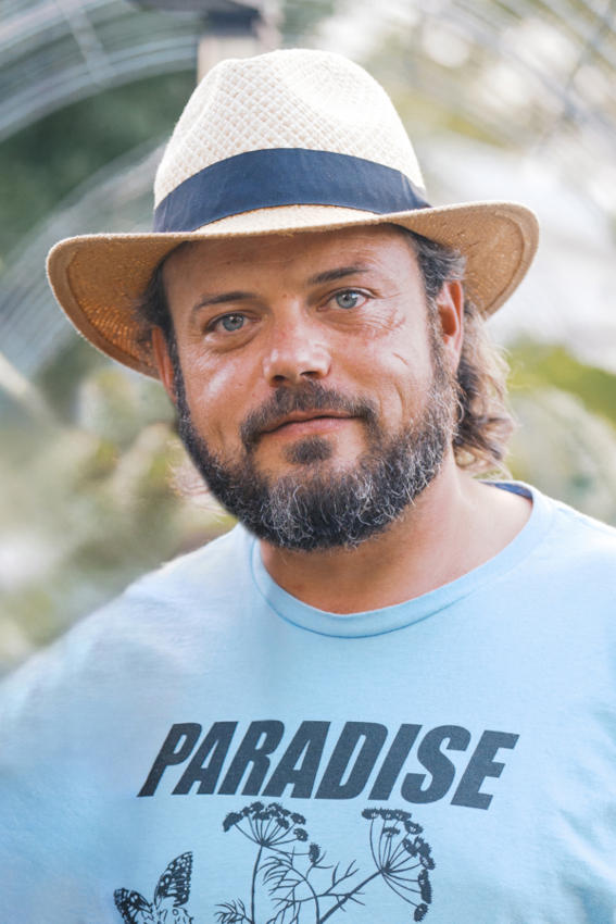 dustin wearing a havana style hat and a blue tee shirt that reads paradise